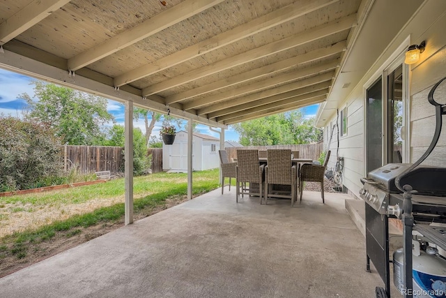 view of patio with grilling area and a storage shed