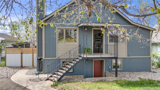 505 S Roosevelt Rd, Lafayette, CO 80026 - back of house with a chimney, fence, and stairway