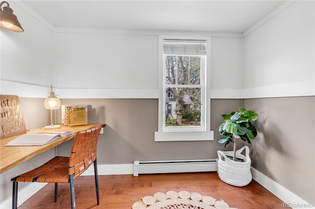 505 S Roosevelt Rd, Lafayette, CO 80026 - home office featuring a baseboard heating unit, wood finished floors, baseboards, and ornamental molding