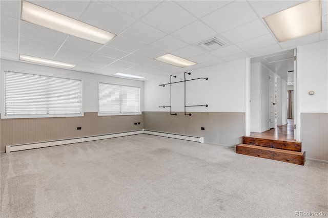 505 S Roosevelt Rd, Lafayette, CO 80026 - spare room featuring wainscoting, carpet floors, a baseboard heating unit, a drop ceiling, and wooden walls