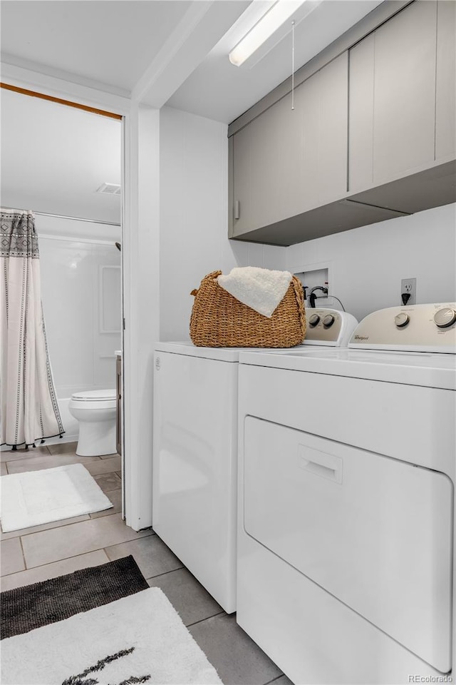 505 S Roosevelt Rd, Lafayette, CO 80026 - laundry area featuring washing machine and dryer, light tile patterned floors, and cabinet space