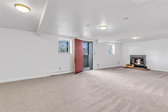 505 S Roosevelt Rd, Lafayette, CO 80026 - below grade area with a baseboard heating unit, carpet, a glass covered fireplace, and baseboards