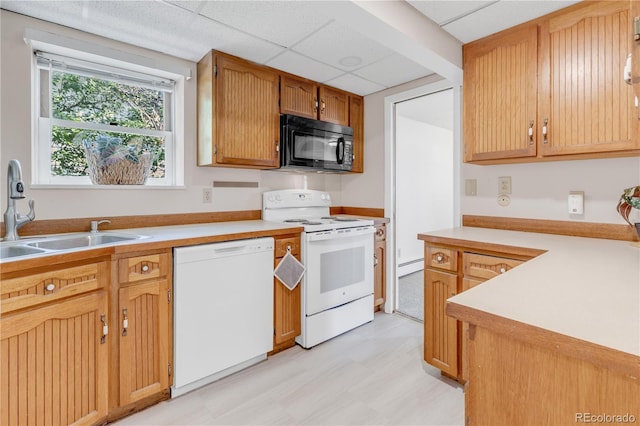 505 S Roosevelt Rd, Lafayette, CO 80026 - kitchen featuring white appliances, a sink, light floors, light countertops, and a drop ceiling