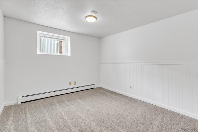 505 S Roosevelt Rd, Lafayette, CO 80026 - empty room with a baseboard heating unit, carpet, and wainscoting