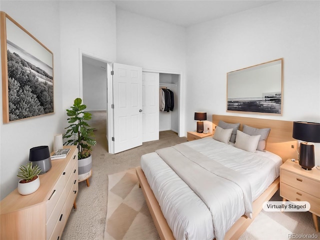 bedroom with a closet and light carpet