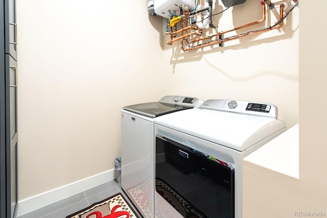 washroom with tile patterned floors and washer and dryer