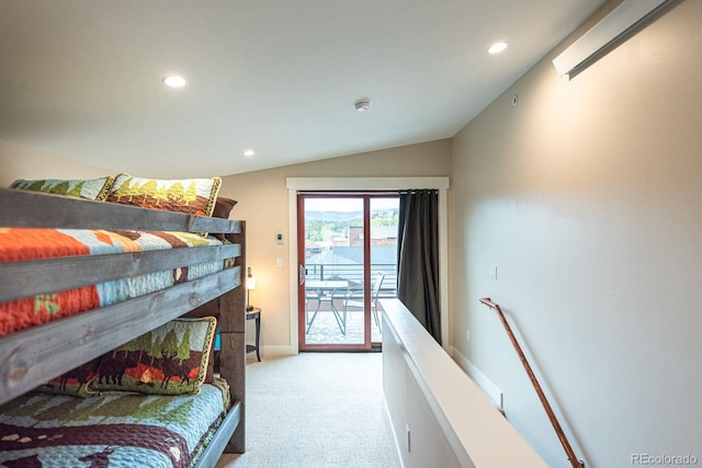 bedroom with vaulted ceiling, light colored carpet, and access to exterior