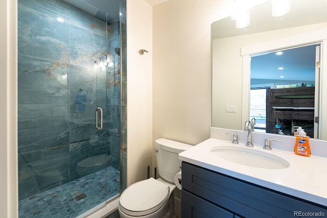 bathroom featuring walk in shower, vanity, and toilet