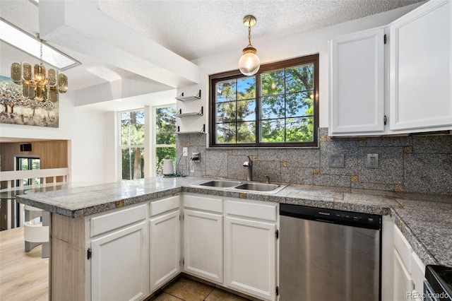 6544 Alkire Ct, Arvada, CO 80004 - kitchen featuring tile counters, dishwasher, a sink, a peninsula, and a textured ceiling