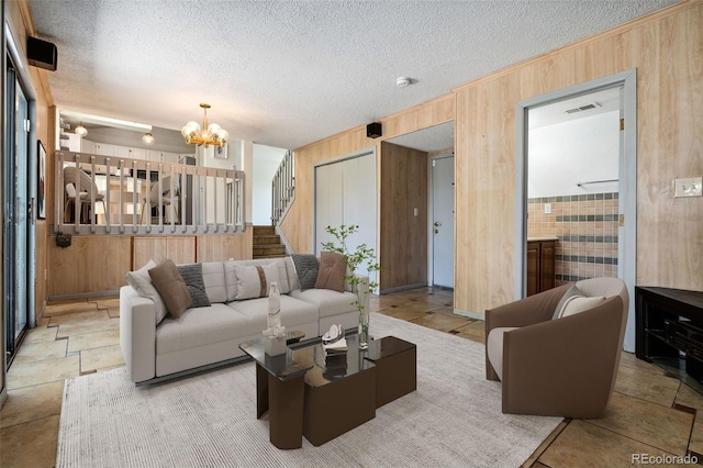 6544 Alkire Ct, Arvada, CO 80004 - living area featuring wood walls, a chandelier, stairs, and a textured ceiling