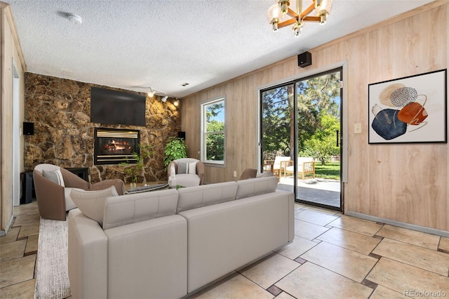 6544 Alkire Ct, Arvada, CO 80004 - living room with wood walls, a fireplace, a textured ceiling, and baseboards