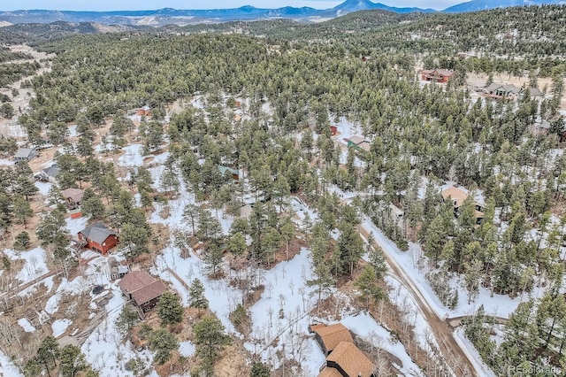 aerial view featuring a mountain view and a forest view