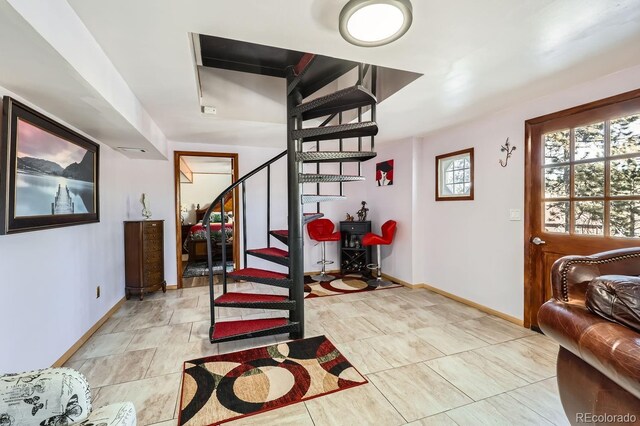 entrance foyer featuring stairs and baseboards