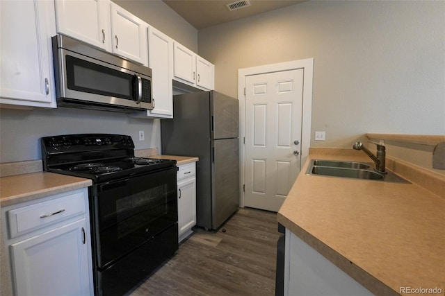 kitchen with sink, dark hardwood / wood-style floors, stainless steel appliances, and white cabinetry