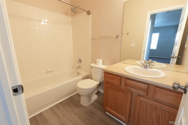 full bathroom featuring vanity, wood-type flooring, shower / bathtub combination, and toilet