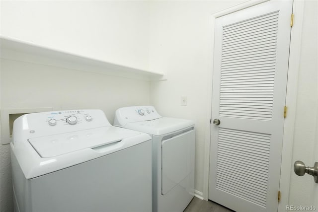 laundry area with wood-type flooring and independent washer and dryer