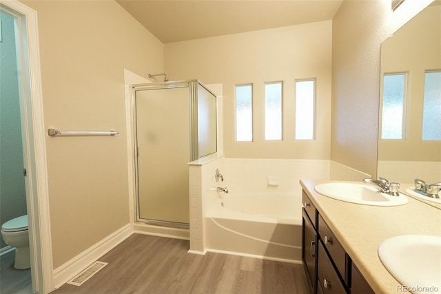 full bathroom featuring hardwood / wood-style flooring, vanity, independent shower and bath, and toilet