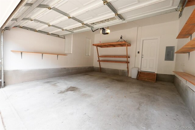 garage with electric panel and a garage door opener