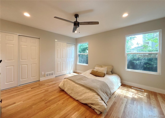 18073 E Belleview Pl, Centennial, CO 80015 - bedroom featuring two closets, light wood finished floors, baseboards, recessed lighting, and ceiling fan