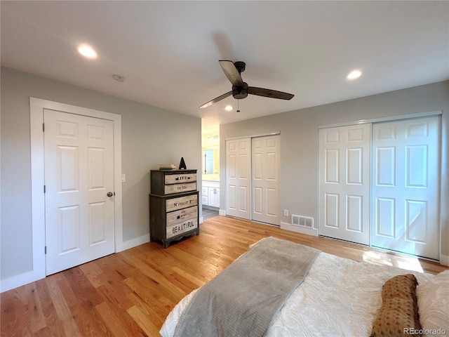 18073 E Belleview Pl, Centennial, CO 80015 - bedroom featuring two closets, light wood-type flooring, baseboards, recessed lighting, and ceiling fan