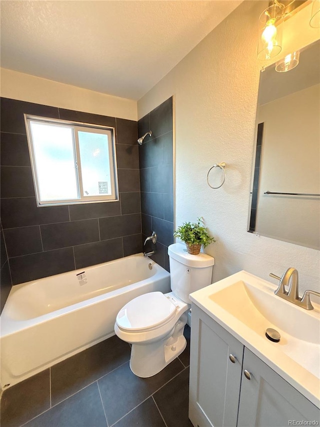 18073 E Belleview Pl, Centennial, CO 80015 - bathroom featuring tile patterned flooring, toilet, vanity, a textured wall, and bathtub / shower combination
