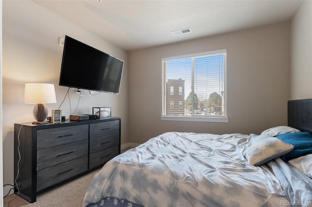bedroom with visible vents and light colored carpet
