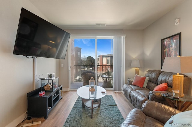 14341 E Tennessee Ave Unit 203, Aurora, CO 80012 - living room with light wood-style floors