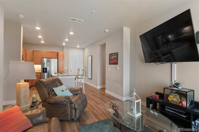 14341 E Tennessee Ave Unit 203, Aurora, CO 80012 - living room featuring light wood-style flooring and recessed lighting