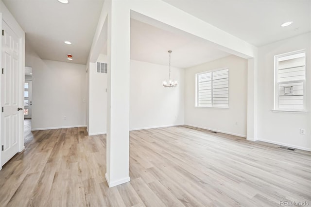 interior space with light hardwood / wood-style flooring and a notable chandelier