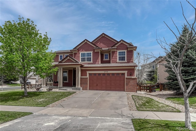 craftsman-style house with an attached garage, brick siding, driveway, and a front yard