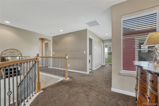 corridor featuring washer / dryer, carpet, an upstairs landing, visible vents, and baseboards