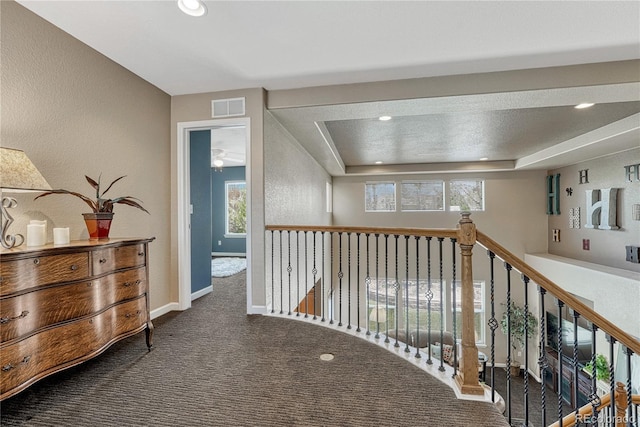 corridor with recessed lighting, plenty of natural light, visible vents, and carpet floors