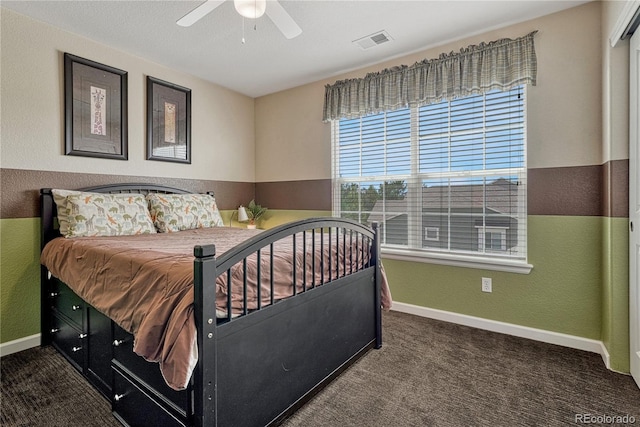 bedroom with carpet, a ceiling fan, visible vents, baseboards, and a textured wall