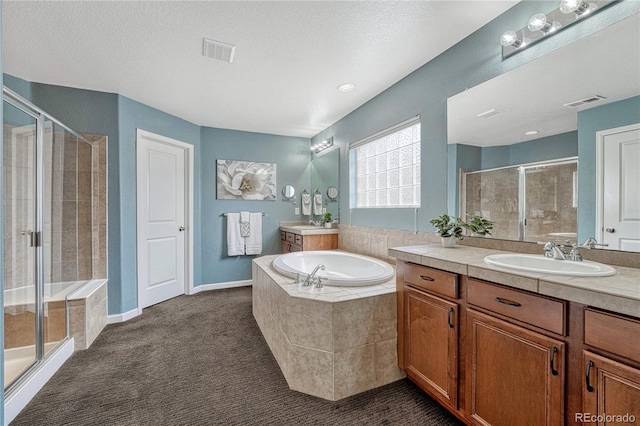 full bathroom with a garden tub, visible vents, a shower stall, and a sink