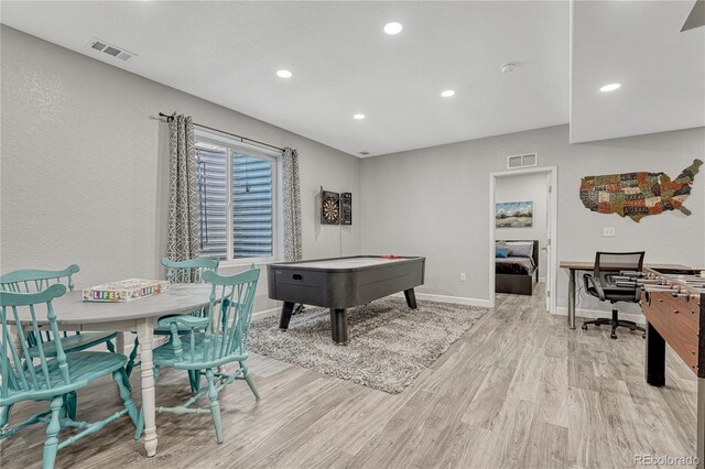 recreation room featuring baseboards, light wood-type flooring, visible vents, and recessed lighting