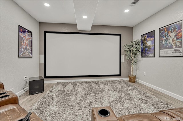 cinema featuring baseboards, visible vents, recessed lighting, and wood finished floors