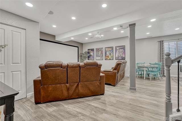 home theater room with baseboards, light wood-type flooring, and recessed lighting