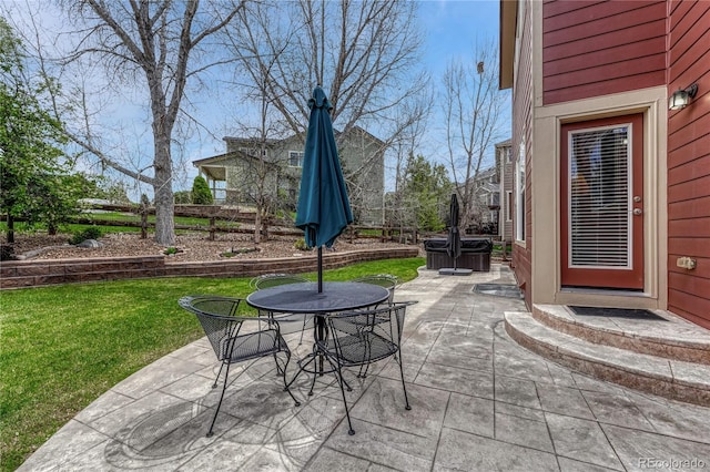 view of patio / terrace with a hot tub and outdoor dining area