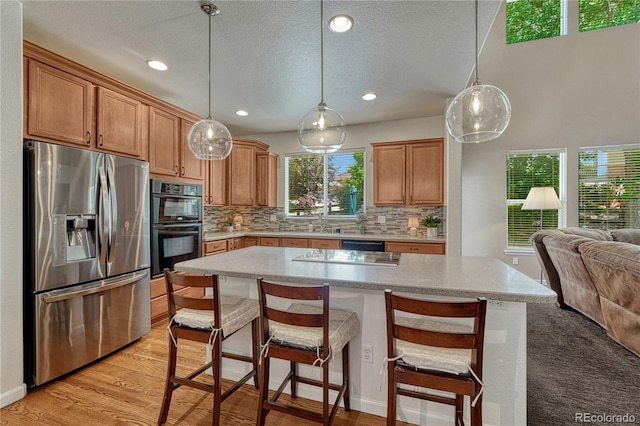 22965 Allendale Ave, Parker, CO 80138 - kitchen featuring black appliances, open floor plan, tasteful backsplash, decorative light fixtures, and recessed lighting