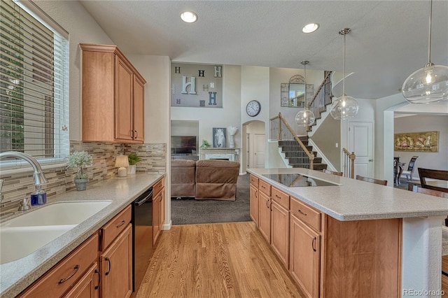 22965 Allendale Ave, Parker, CO 80138 - kitchen with black electric stovetop, a fireplace, light wood finished floors, dishwashing machine, and light countertops