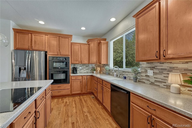 22965 Allendale Ave, Parker, CO 80138 - kitchen featuring black appliances, light wood finished floors, backsplash, recessed lighting, and light countertops