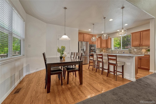 22965 Allendale Ave, Parker, CO 80138 - dining space with light wood-style flooring, recessed lighting, and a textured ceiling