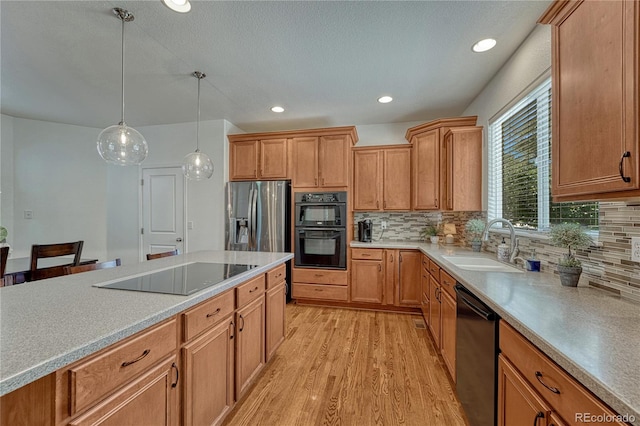 22965 Allendale Ave, Parker, CO 80138 - kitchen featuring black appliances, light wood-style floors, backsplash, hanging light fixtures, and recessed lighting