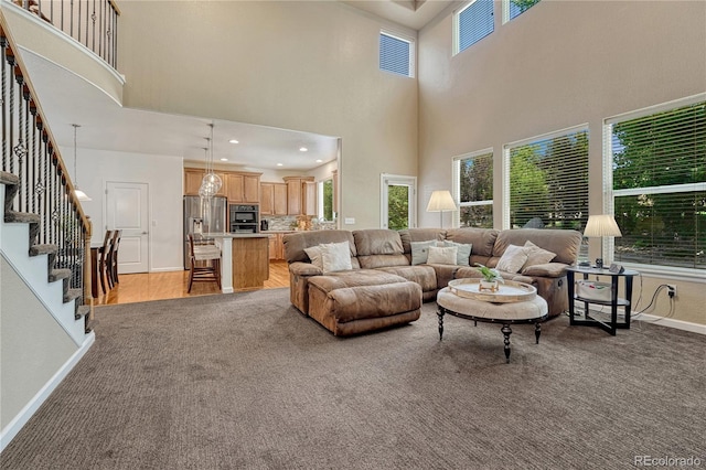 22965 Allendale Ave, Parker, CO 80138 - living area with a towering ceiling, light colored carpet, and stairway
