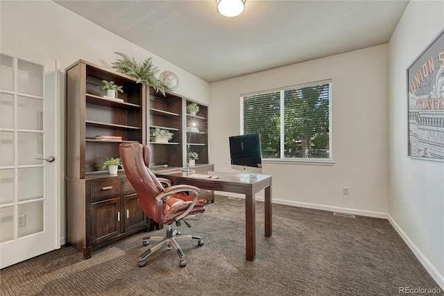 22965 Allendale Ave, Parker, CO 80138 - home office featuring dark colored carpet and baseboards