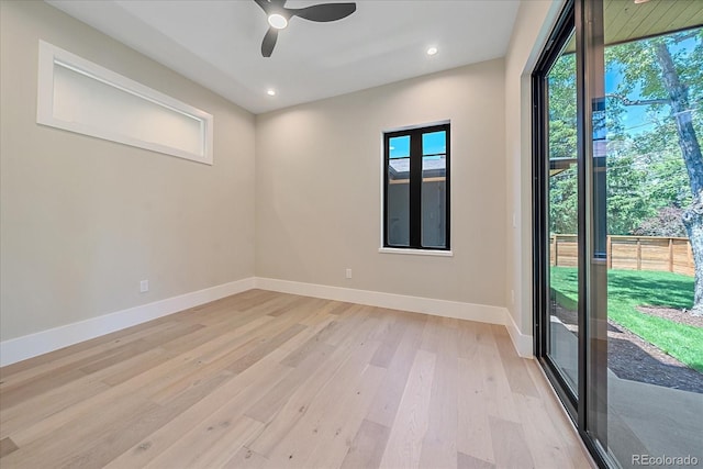 spare room with light hardwood / wood-style floors and ceiling fan