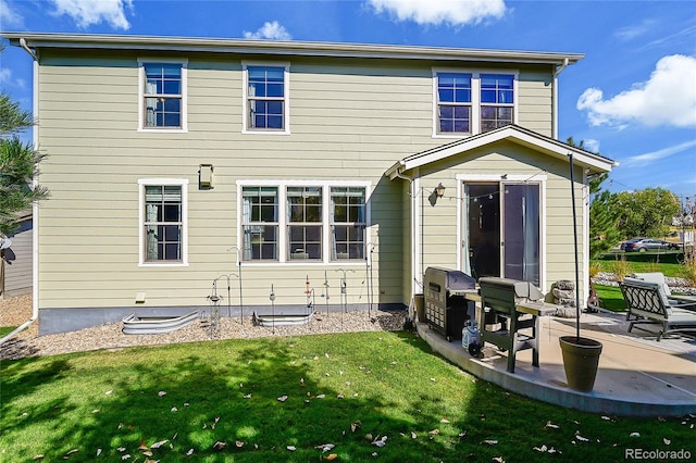 rear view of property with a lawn and a patio