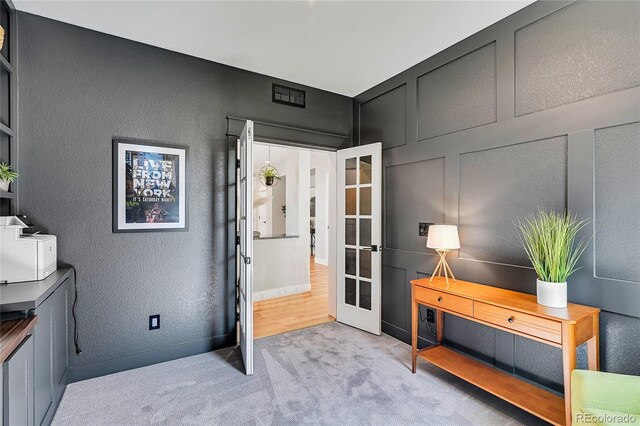 office area with light carpet and french doors