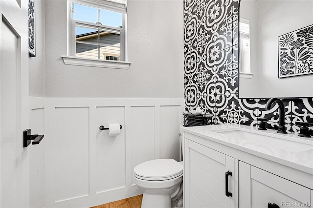 bathroom with vanity, wood-type flooring, and toilet