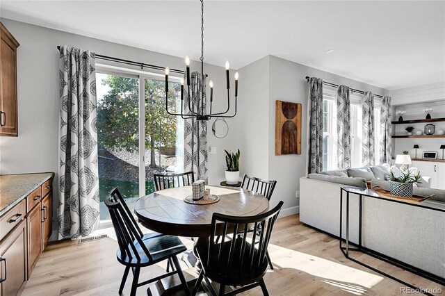 dining area with a chandelier and light wood-type flooring